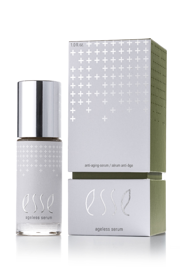 The Esse Ageless Serum, topped with a silver cap, is shown beside its white and green box. Both the bottle and box feature silver cross patterns and minimalist text.