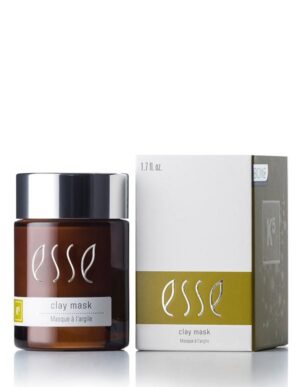 An image displaying the Esse Clay Mask shows a brown jar with a black lid and a white label featuring the brand name "Esse" and the text "clay mask Masque à l’argile." Accompanying it is a white box with matching branding and a green accent on the front.