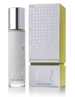 A bottle of Esse Defence Moisturiser with a silver cap stands beside its matching silver and yellow box, both displaying a minimalist design with crosses and the product name: Esse Defence Moisturiser.