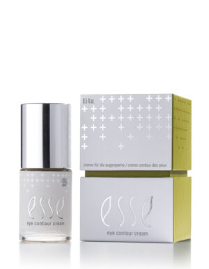 A small bottle of Esse Eye Contour Cream with a silver cap sits beside its white and green box, decorated with minimalist plus signs and product details in English, French, and German.