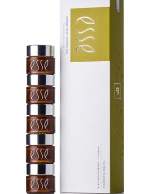 A stack of five small brown jars with silver lids, labeled "Esse Omega Rich Moisturiser," is placed next to a white and green box with the same branding. The box displays product information and appears to contain skincare items.