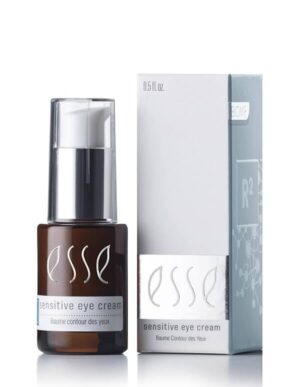 The image features a small bottle of Esse Sensitive Eye Cream beside its box packaging. The dark amber bottle, adorned with white text, includes a convenient pump dispenser. The light grey packaging displays matching white text and prominently shows the product name, Esse Sensitive Eye Cream.