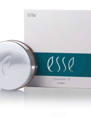 A round, silver compact container featuring a minimalist leaf logo is placed in front of its matching box. The box also displays the same leaf logo and is labeled "Esse Concealer 10" with text indicating "0.17 fl. oz." and featuring a teal band across the middle.